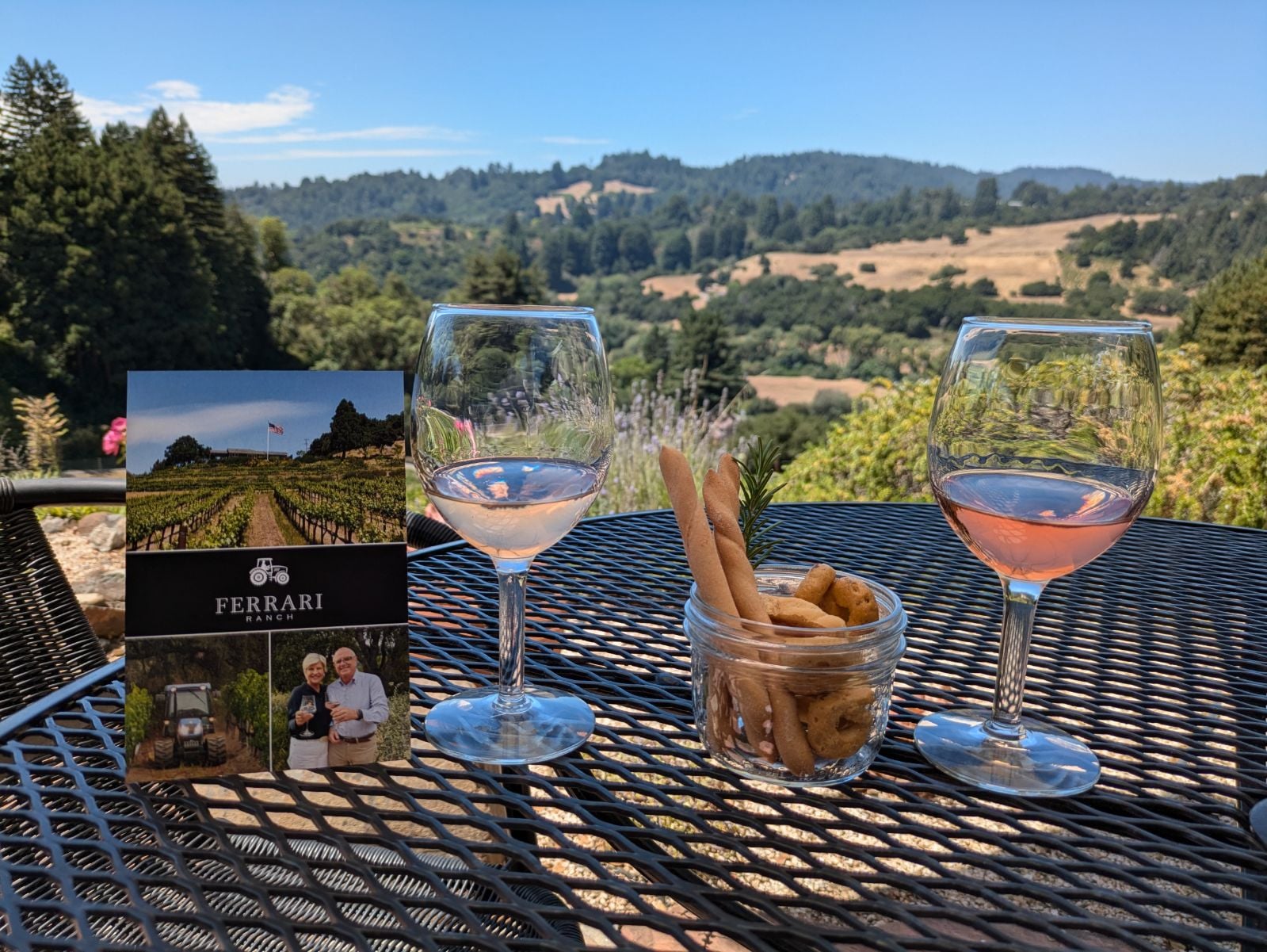 Wine glasses on a table overlooking the vineyard at Ferrari Ranch, Corralitos